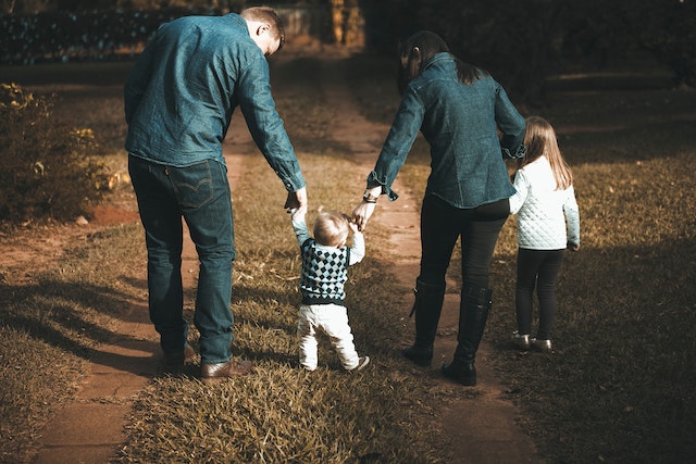 A family walking together on an outdoor path.